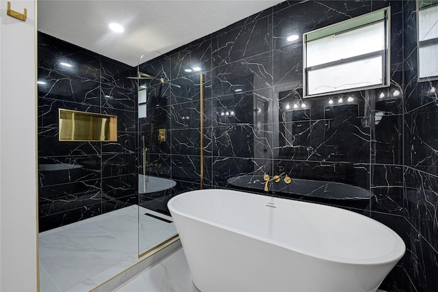 910 Woodchurch Ln, Houston, TX 77073 - full bathroom with tile walls, marble tiled flooring, a freestanding bath, a marble finish shower, and recessed lighting