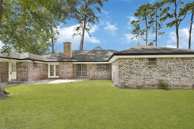910 Woodchurch Ln, Houston, TX 77073 - back of house featuring french doors, a chimney, a yard, a patio, and brick siding
