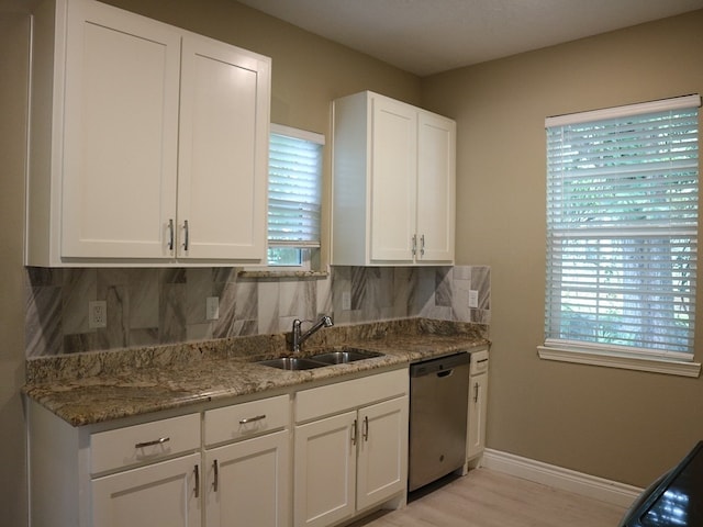 1306 S Austin St, Brenham, TX 77833 - kitchen with dishwasher, backsplash, plenty of natural light, and white cabinetry