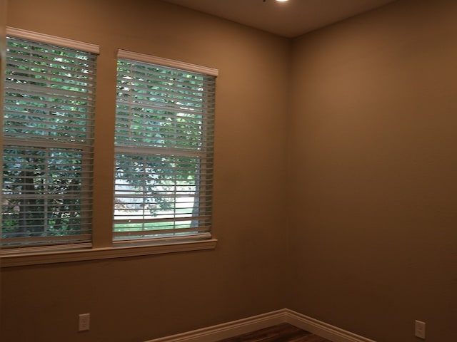 1306 S Austin St, Brenham, TX 77833 - empty room featuring baseboards and dark wood-style floors
