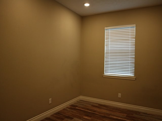 1306 S Austin St, Brenham, TX 77833 - empty room with dark wood-type flooring and recessed lighting