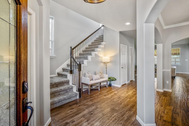 7214 Emerald Run Ln, Spring, TX 77379 - foyer entrance featuring arched walkways, stairs, wood finished floors, crown molding, and recessed lighting