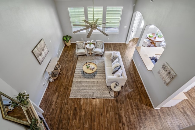 7214 Emerald Run Ln, Spring, TX 77379 - living area featuring wood finished floors, arched walkways, and ceiling fan