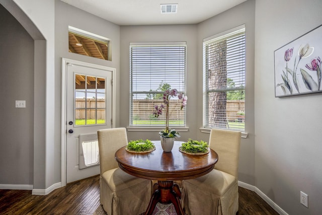 7214 Emerald Run Ln, Spring, TX 77379 - dining space featuring dark wood-type flooring and arched walkways