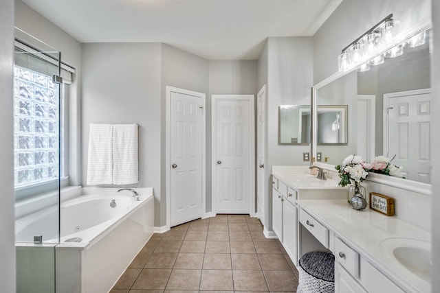 7214 Emerald Run Ln, Spring, TX 77379 - bathroom featuring healthy amount of natural light, double vanity, a tub with jets, and tile patterned floors