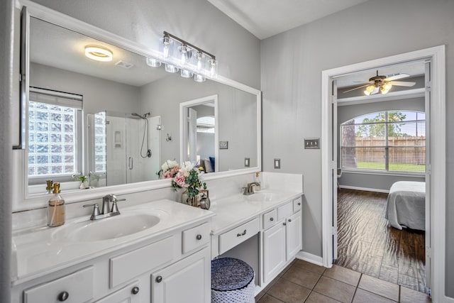 7214 Emerald Run Ln, Spring, TX 77379 - ensuite bathroom featuring double vanity, a stall shower, healthy amount of natural light, and tile patterned floors