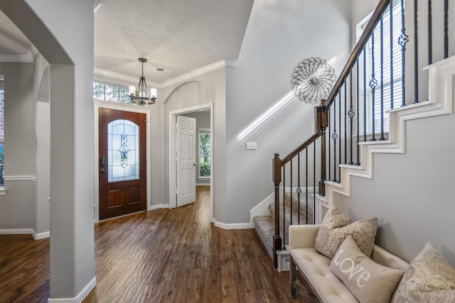 7214 Emerald Run Ln, Spring, TX 77379 - entrance foyer with a chandelier, arched walkways, crown molding, wood finished floors, and stairs