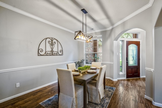 7214 Emerald Run Ln, Spring, TX 77379 - dining space featuring wood finished floors, arched walkways, crown molding, and a chandelier