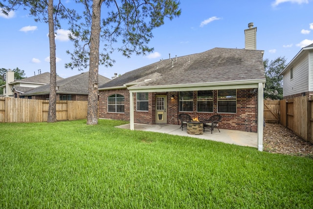 7214 Emerald Run Ln, Spring, TX 77379 - rear view of house featuring a patio, brick siding, a fenced backyard, an outdoor fire pit, and a shingled roof