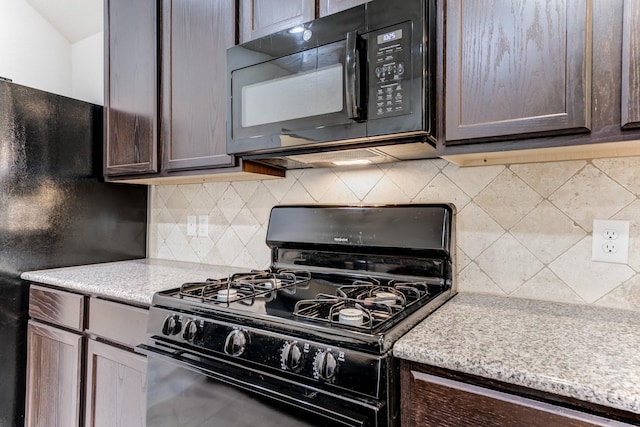14726 Lark Sky Way, Cypress, TX 77429 - kitchen with black appliances, light countertops, dark brown cabinetry, and backsplash