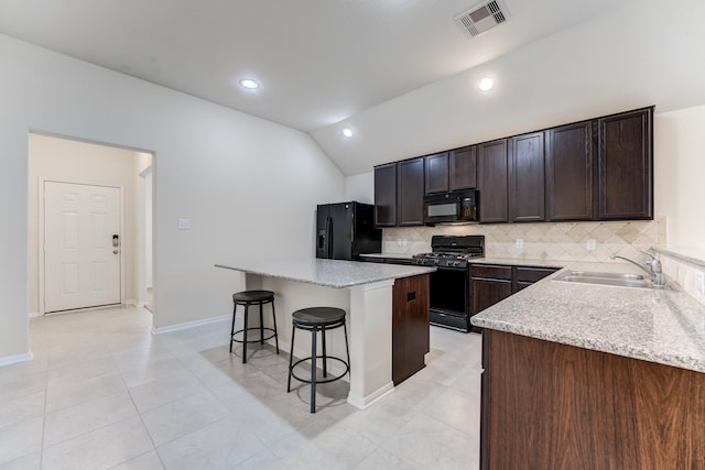 14726 Lark Sky Way, Cypress, TX 77429 - kitchen with black appliances, a kitchen breakfast bar, decorative backsplash, lofted ceiling, and a center island