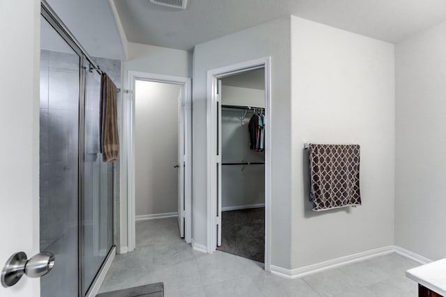 14726 Lark Sky Way, Cypress, TX 77429 - bathroom with a shower stall, a spacious closet, tile patterned flooring, and vanity