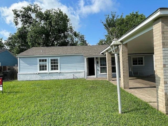 5746 Groveton St, Houston, TX 77033 - view of front facade featuring a front lawn, roof with shingles, and a patio