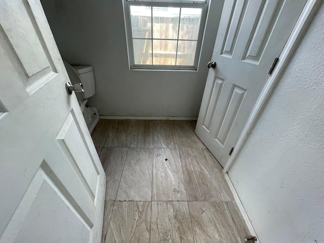 5746 Groveton St, Houston, TX 77033 - bathroom featuring baseboards and wood finished floors