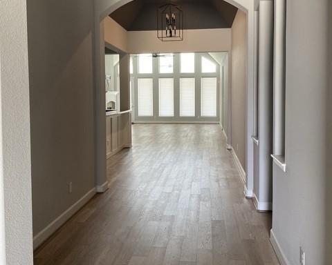 19007 Dappled Mare Cir, Tomball, TX 77377 - hall with arched walkways, wood finished floors, a chandelier, and lofted ceiling