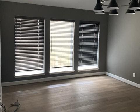 19007 Dappled Mare Cir, Tomball, TX 77377 - empty room with healthy amount of natural light and wood finished floors