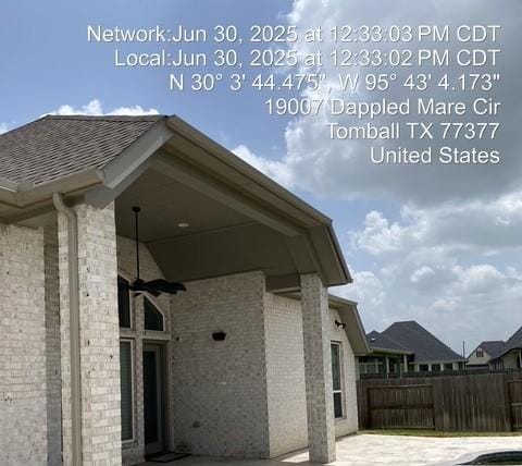 19007 Dappled Mare Cir, Tomball, TX 77377 - view of side of home featuring brick siding, a patio area, and a shingled roof