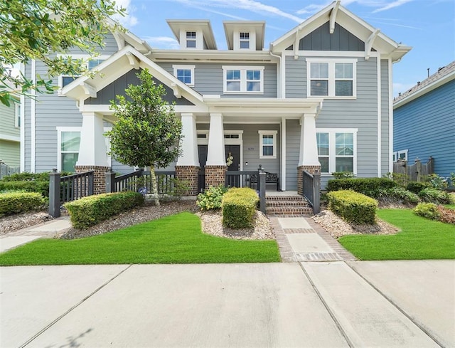 17023 Canosa Dr, Cypress, TX 77433 - craftsman-style home with a porch, brick siding, and board and batten siding