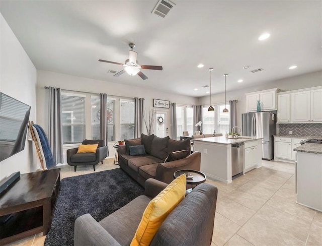 17023 Canosa Dr, Cypress, TX 77433 - living area featuring healthy amount of natural light, ceiling fan, light tile patterned floors, and recessed lighting