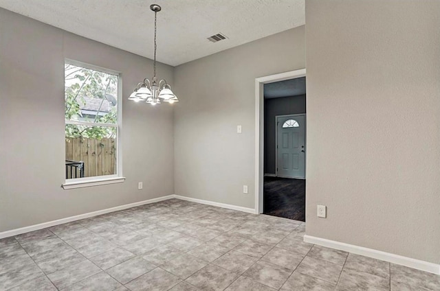 4137 Galesburg St, Houston, TX 77051 - spare room with a chandelier, tile patterned floors, and a textured ceiling