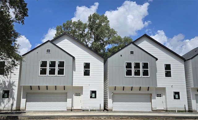4922 Hoover St Unit A, Houston, TX 77092 - view of front facade with board and batten siding and a garage