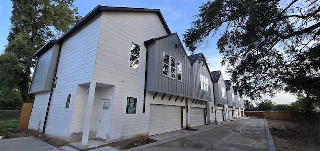 4922 Hoover St Unit A, Houston, TX 77092 - rear view of property featuring a garage, board and batten siding, and concrete driveway