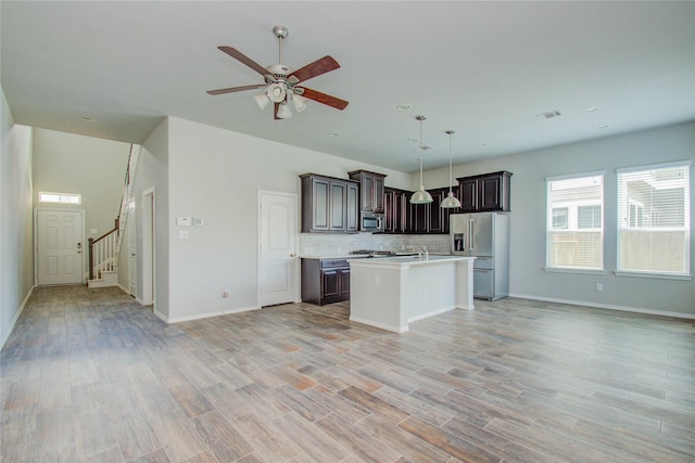 17019 Canosa Dr, Cypress, TX 77433 - kitchen with appliances with stainless steel finishes, open floor plan, light countertops, ceiling fan, and dark brown cabinetry