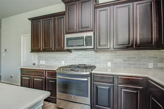17019 Canosa Dr, Cypress, TX 77433 - kitchen featuring stainless steel appliances, light countertops, decorative backsplash, and dark brown cabinetry