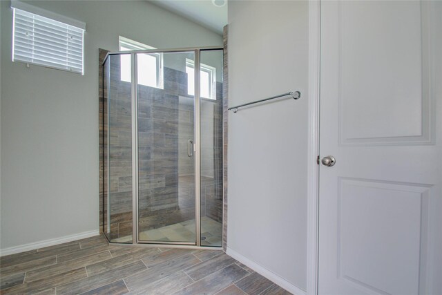 17019 Canosa Dr, Cypress, TX 77433 - bathroom with wood tiled floors, a shower stall, and lofted ceiling