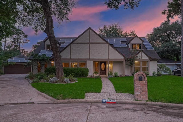 5942 Pebble Springs Dr, Houston, TX 77066 - view of front of house featuring a front lawn, solar panels, concrete driveway, and an attached garage