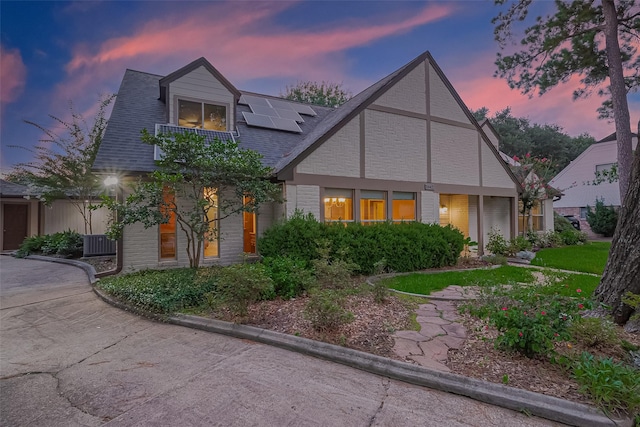 5942 Pebble Springs Dr, Houston, TX 77066 - tudor home featuring solar panels and roof with shingles