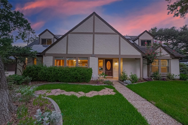 5942 Pebble Springs Dr, Houston, TX 77066 - view of front of home featuring a yard and brick siding