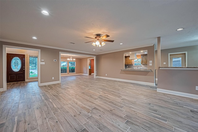 5942 Pebble Springs Dr, Houston, TX 77066 - unfurnished living room featuring a chandelier, recessed lighting, light wood-type flooring, a ceiling fan, and ornamental molding