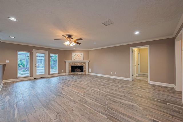 5942 Pebble Springs Dr, Houston, TX 77066 - unfurnished living room featuring light wood-style floors, a ceiling fan, ornamental molding, recessed lighting, and a fireplace