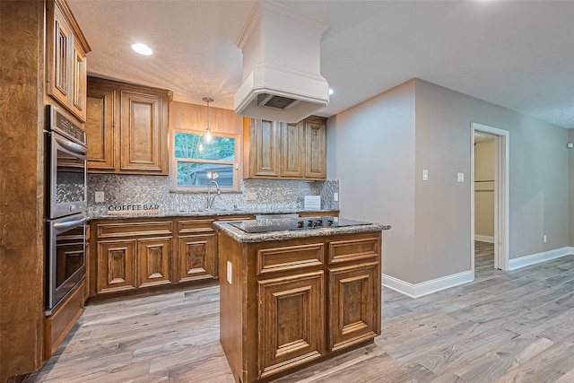 5942 Pebble Springs Dr, Houston, TX 77066 - kitchen featuring double oven, custom range hood, light wood-type flooring, decorative backsplash, and stone countertops