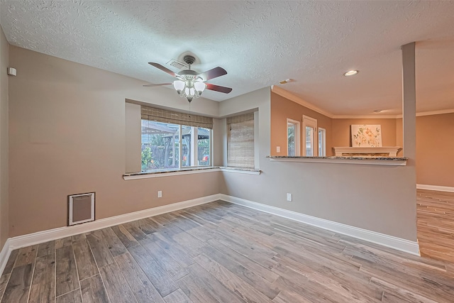 5942 Pebble Springs Dr, Houston, TX 77066 - empty room with wood finished floors, ceiling fan, a textured ceiling, and recessed lighting