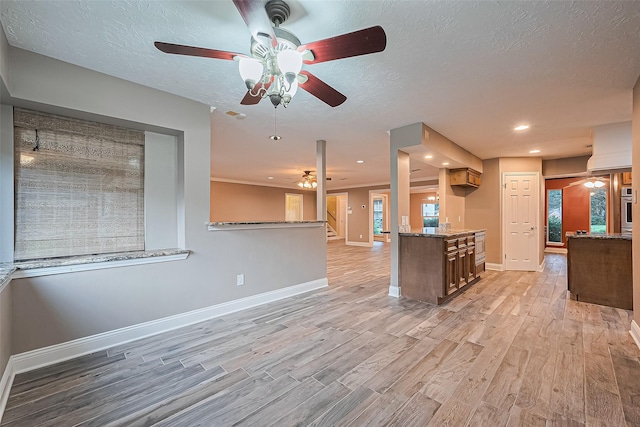 5942 Pebble Springs Dr, Houston, TX 77066 - kitchen with a ceiling fan, light wood finished floors, light stone counters, oven, and open floor plan