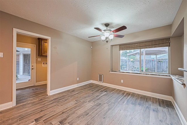 5942 Pebble Springs Dr, Houston, TX 77066 - spare room with a ceiling fan, wood finished floors, and a textured ceiling
