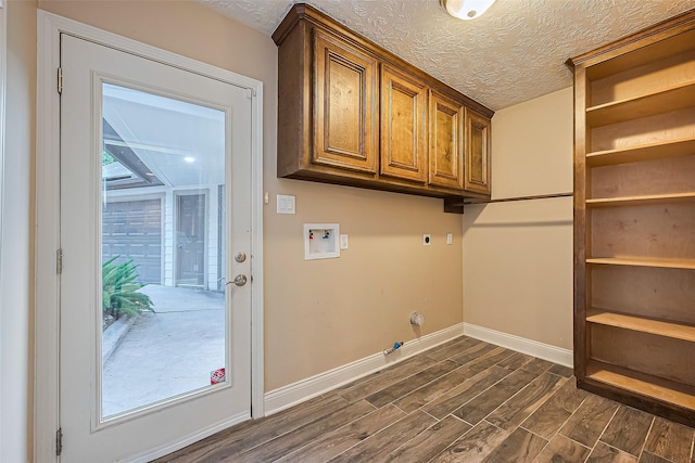 5942 Pebble Springs Dr, Houston, TX 77066 - washroom with washer hookup, hookup for an electric dryer, gas dryer hookup, dark wood finished floors, and cabinet space