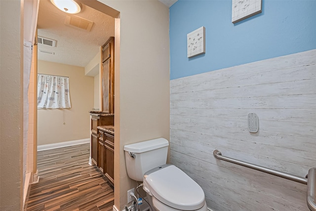 5942 Pebble Springs Dr, Houston, TX 77066 - bathroom featuring wood finished floors, vanity, and a textured ceiling