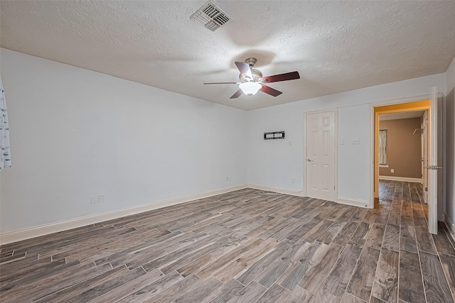 5942 Pebble Springs Dr, Houston, TX 77066 - spare room featuring wood finished floors, ceiling fan, and a textured ceiling