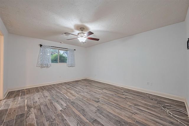5942 Pebble Springs Dr, Houston, TX 77066 - spare room with wood finished floors, ceiling fan, and a textured ceiling