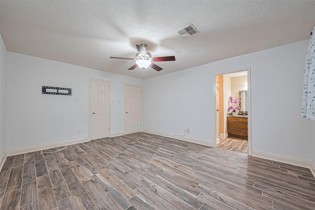 5942 Pebble Springs Dr, Houston, TX 77066 - spare room featuring wood finished floors, a ceiling fan, and a textured ceiling