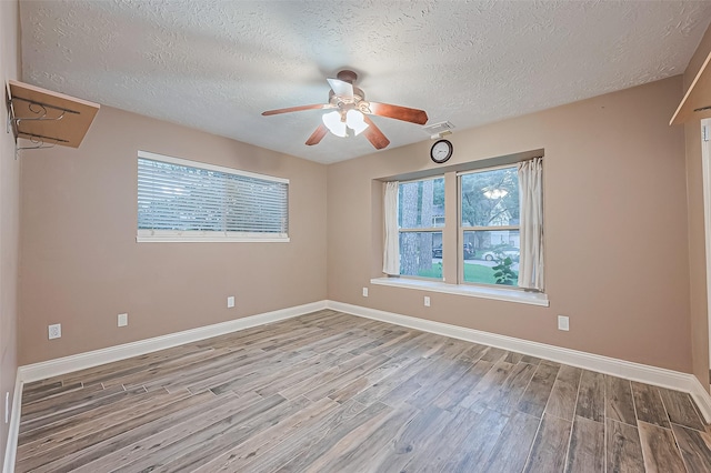 5942 Pebble Springs Dr, Houston, TX 77066 - spare room with wood finished floors, a textured ceiling, and a ceiling fan