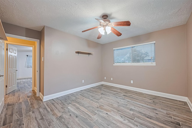 5942 Pebble Springs Dr, Houston, TX 77066 - empty room featuring wood finished floors, ceiling fan, and a textured ceiling