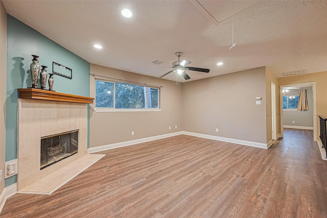 5942 Pebble Springs Dr, Houston, TX 77066 - unfurnished living room featuring attic access, wood finished floors, recessed lighting, a tile fireplace, and ceiling fan