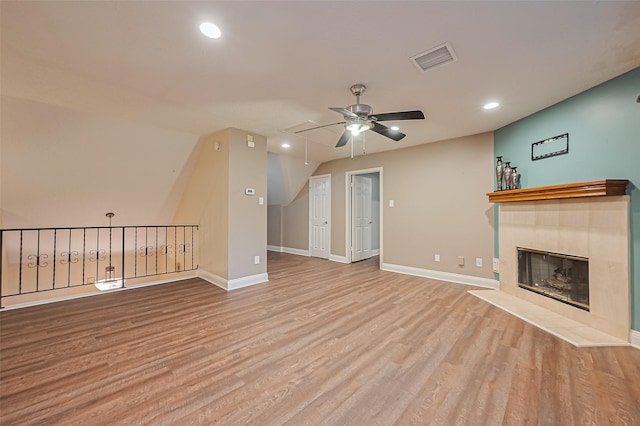 5942 Pebble Springs Dr, Houston, TX 77066 - unfurnished living room with a ceiling fan, wood finished floors, recessed lighting, a tiled fireplace, and attic access