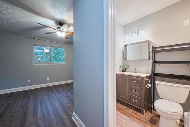 5942 Pebble Springs Dr, Houston, TX 77066 - half bath with wood finished floors, a textured ceiling, vanity, and a ceiling fan