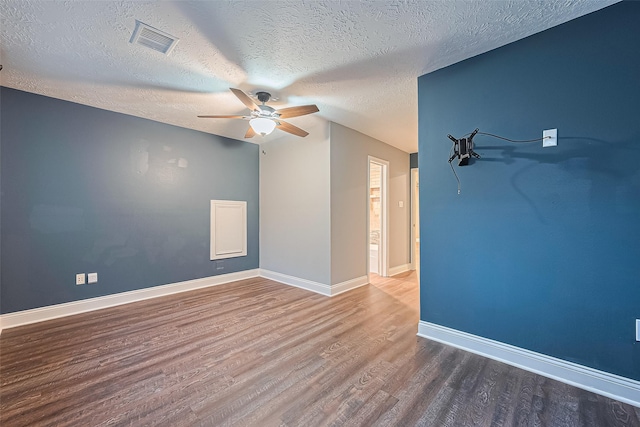 5942 Pebble Springs Dr, Houston, TX 77066 - unfurnished room with a ceiling fan, wood finished floors, and a textured ceiling