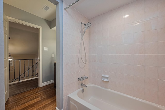 5942 Pebble Springs Dr, Houston, TX 77066 - bathroom featuring washtub / shower combination and wood finished floors